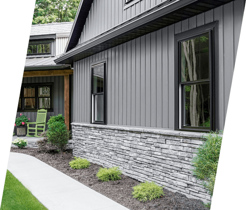 a nice home with vinyl siding and stone siding